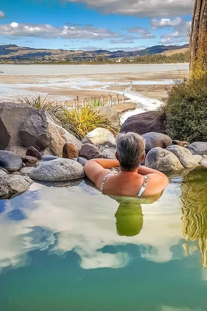 Woman sitting in thermal rock pool