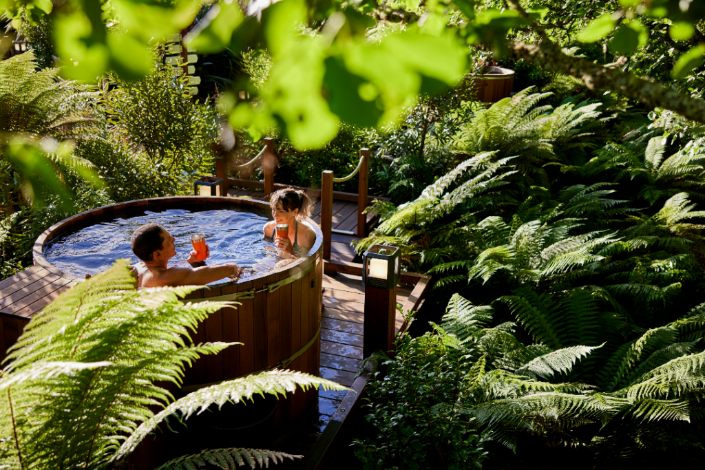 A couple in a hot tub in a forest