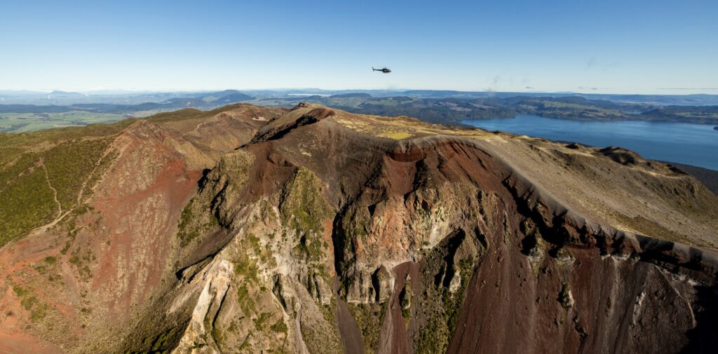 helicopter flying over summit of Mount Tarawera's craters
