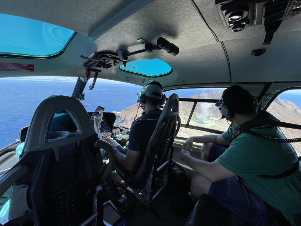 passengers looking out heli windows at White Island